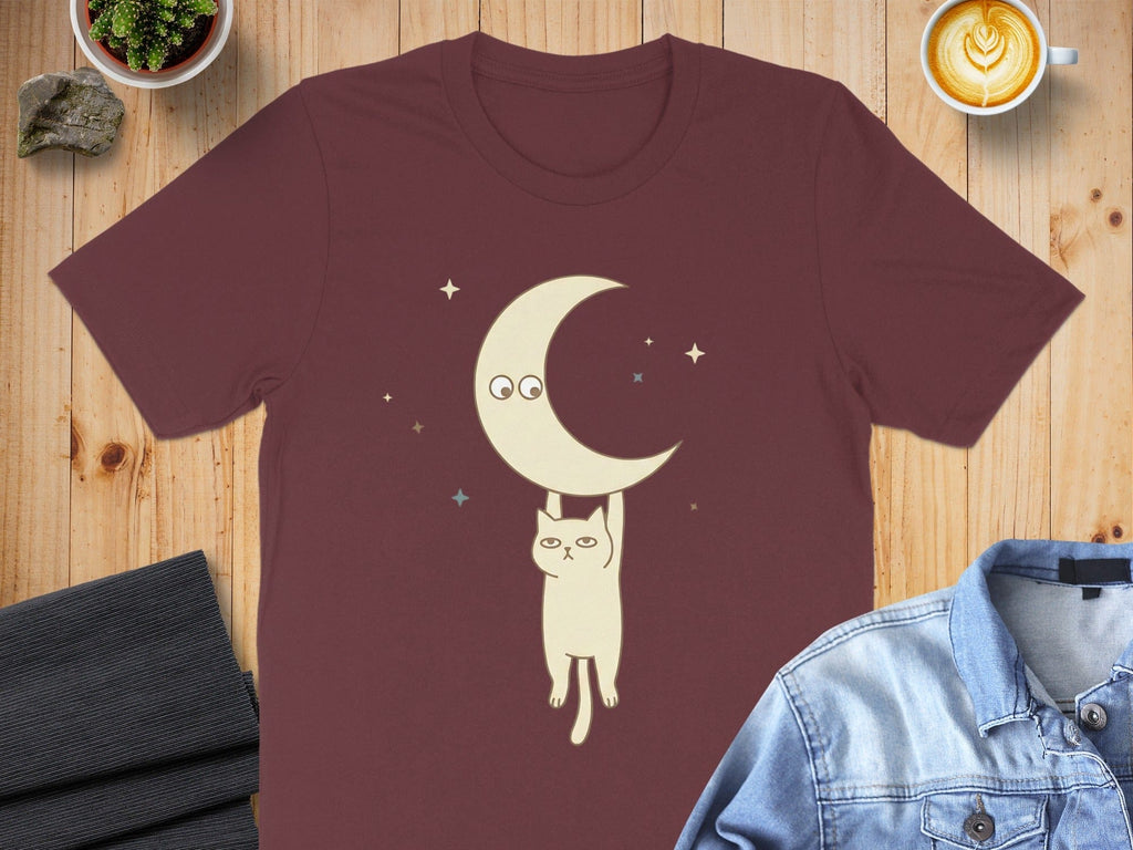 Cat Hanging from Moon Graphic Design T-shirt